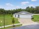 Beautiful home featuring a three-car garage, manicured lawn, and well-maintained landscaping, set in a lush, green neighborhood at 1278 Asher Mason Ave, Kissimmee, FL 34744