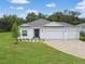 Beautiful home featuring a three-car garage, manicured lawn, and well-maintained landscaping, set in a lush, green neighborhood at 1278 Asher Mason Ave, Kissimmee, FL 34744