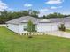 Charming single-story home featuring a manicured lawn, complemented by a three-car garage and tasteful landscaping at 1278 Asher Mason Ave, Kissimmee, FL 34744