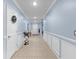 Bright hallway with blue walls, tiled floor, white trim, and tastefully decorated with elegant decor at 1278 Asher Mason Ave, Kissimmee, FL 34744
