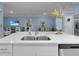 Open kitchen island with stainless sink and dishwasher overlooks the dining area and Gathering room at 1278 Asher Mason Ave, Kissimmee, FL 34744