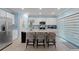 Bright kitchen features a large island with bar seating, stainless steel appliances, and modern fixtures at 1278 Asher Mason Ave, Kissimmee, FL 34744