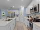 Spacious kitchen with island, stainless steel appliances, white cabinetry, and light countertops at 1278 Asher Mason Ave, Kissimmee, FL 34744
