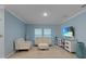 Cozy living room with tile floors, blue walls, two front facing windows, and a modern entertainment center at 1278 Asher Mason Ave, Kissimmee, FL 34744