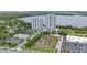 Aerial view of resort-style condominium buildings with a mini-golf course and commercial space, near a picturesque lake at 13415 Blue Heron Beach Dr # 401, Orlando, FL 32821