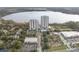 Aerial view of the condo complex and lake, with an outdoor mini golf course at 13415 Blue Heron Beach Dr # 401, Orlando, FL 32821