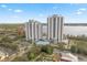 Aerial view of the condo buildings including pool, parking, miniature golf, and surrounding landscape at 13415 Blue Heron Beach Dr # 401, Orlando, FL 32821