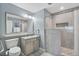 Bright bathroom featuring a spacious walk-in shower and a well-lit vanity with a large mirror at 13415 Blue Heron Beach Dr # 401, Orlando, FL 32821