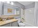 Well-lit bathroom with a bathtub, shower, and granite vanity at 13415 Blue Heron Beach Dr # 401, Orlando, FL 32821