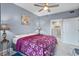 Well-lit bedroom with modern decor, a ceiling fan, and a view of the shower at 13415 Blue Heron Beach Dr # 401, Orlando, FL 32821