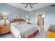 Cozy bedroom with ceiling fan, stylish furnishings, and attached bathroom at 13415 Blue Heron Beach Dr # 401, Orlando, FL 32821
