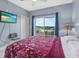 Comfortable bedroom featuring a plush bed, scenic views from the balcony, and a wall-mounted TV for relaxation at 13415 Blue Heron Beach Dr # 401, Orlando, FL 32821