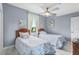 Bright bedroom with two twin beds, a ceiling fan, and a view of the outdoors at 13415 Blue Heron Beach Dr # 401, Orlando, FL 32821