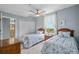 Comfortable bedroom featuring twin beds, a ceiling fan, closet, and a window with scenic outdoor views at 13415 Blue Heron Beach Dr # 401, Orlando, FL 32821