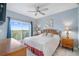 Cozy bedroom with view, ceiling fan, and stylish furnishings at 13415 Blue Heron Beach Dr # 401, Orlando, FL 32821