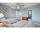 Inviting bedroom with twin beds, dresser, and ceiling fan, creating a cozy and relaxing atmosphere at 13415 Blue Heron Beach Dr # 401, Orlando, FL 32821