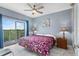 Bright bedroom with a balcony offering scenic views, complemented by stylish furnishings and decor at 13415 Blue Heron Beach Dr # 401, Orlando, FL 32821