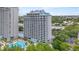 Elegant building exterior showcasing private balconies, offering serene views and a glimpse of the community pool at 13415 Blue Heron Beach Dr # 401, Orlando, FL 32821