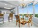 Dining area with large windows providing panoramic views and a stylish light fixture at 13415 Blue Heron Beach Dr # 401, Orlando, FL 32821