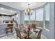 Cozy dining area with chandelier lighting and a view of the kitchen and outside view at 13415 Blue Heron Beach Dr # 401, Orlando, FL 32821