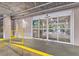 Entrance of Tower One featuring sliding glass doors leading to the elevators with yellow safety barriers at 13415 Blue Heron Beach Dr # 401, Orlando, FL 32821