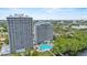 Aerial exterior shot of two high-rise buildings with lake and pool at 13415 Blue Heron Beach Dr # 401, Orlando, FL 32821