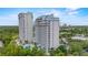 Exterior view of condo with lake in the background at 13415 Blue Heron Beach Dr # 401, Orlando, FL 32821