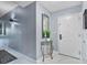 Inviting foyer with white marble floors, a glass table, and a decorative mirror enhancing the welcoming ambiance at 13415 Blue Heron Beach Dr # 401, Orlando, FL 32821