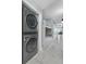 Hallway area with stacked washer/dryer and cozy bunk beds, all illuminated by modern lighting at 13415 Blue Heron Beach Dr # 401, Orlando, FL 32821