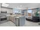 Open-concept kitchen featuring stainless steel appliances and an island overlooking the living area and scenic views at 13415 Blue Heron Beach Dr # 401, Orlando, FL 32821