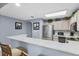 Well-equipped kitchen with modern appliances, granite countertops, and breakfast bar seating at 13415 Blue Heron Beach Dr # 401, Orlando, FL 32821