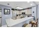 Bright kitchen featuring stainless steel appliances, a breakfast bar, and ample counter space at 13415 Blue Heron Beach Dr # 401, Orlando, FL 32821
