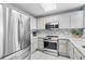 Modern kitchen with stainless steel appliances and white cabinets at 13415 Blue Heron Beach Dr # 401, Orlando, FL 32821