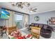Inviting living room and dining space with water views from the large sliding glass doors at 13415 Blue Heron Beach Dr # 401, Orlando, FL 32821