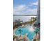 Overhead shot of a pool, pier, and lake, creating a perfect backdrop for relaxation at 13415 Blue Heron Beach Dr # 401, Orlando, FL 32821