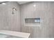 A luxurious tile shower with a built-in niche for storage at 13415 Blue Heron Beach Dr # 401, Orlando, FL 32821