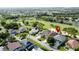 Aerial view of house near a golf course and green neighborhood at 1426 Park Park, Haines City, FL 33844