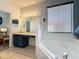 Bright bathroom with double sink vanity, a soaking tub, and a window offering natural light at 1426 Park Park, Haines City, FL 33844