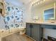 Bright bathroom with a vanity, toilet, and tub-shower combination with a decorative shower curtain at 1426 Park Park, Haines City, FL 33844
