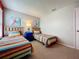 Bedroom with two twin beds, bright colors, a window with blinds, and beige carpet at 1426 Park Park, Haines City, FL 33844