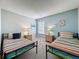 Cozy bedroom features twin beds with colorful striped bedding and complimentary decor at 1426 Park Park, Haines City, FL 33844