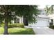 Home featuring a well-maintained front yard, two car garage, and classic curb appeal at 1426 Park Park, Haines City, FL 33844
