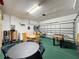 Spacious garage furnished with tables, foosball, and basketball at 1426 Park Park, Haines City, FL 33844