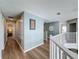 Upstairs hallway with wood floors, painted walls, and a view of other rooms at 1426 Park Park, Haines City, FL 33844