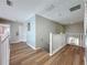 Bright hallway with wood floors and white railings leading to other rooms at 1426 Park Park, Haines City, FL 33844