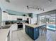 Modern kitchen featuring a center island, updated appliances, and easy access to the outdoor pool at 1426 Park Park, Haines City, FL 33844