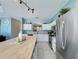 Well-lit kitchen featuring stainless steel appliances, white cabinetry, and a butcher block island at 1426 Park Park, Haines City, FL 33844
