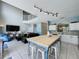Open-concept kitchen with an island and stools, adjacent to the living room and staircase at 1426 Park Park, Haines City, FL 33844
