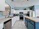 Kitchen with stainless appliances, white cabinets, a butcher block island, and tile flooring at 1426 Park Park, Haines City, FL 33844