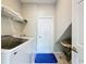 Well-lit laundry room featuring a washer and dryer and convenient overhead shelving at 1426 Park Park, Haines City, FL 33844